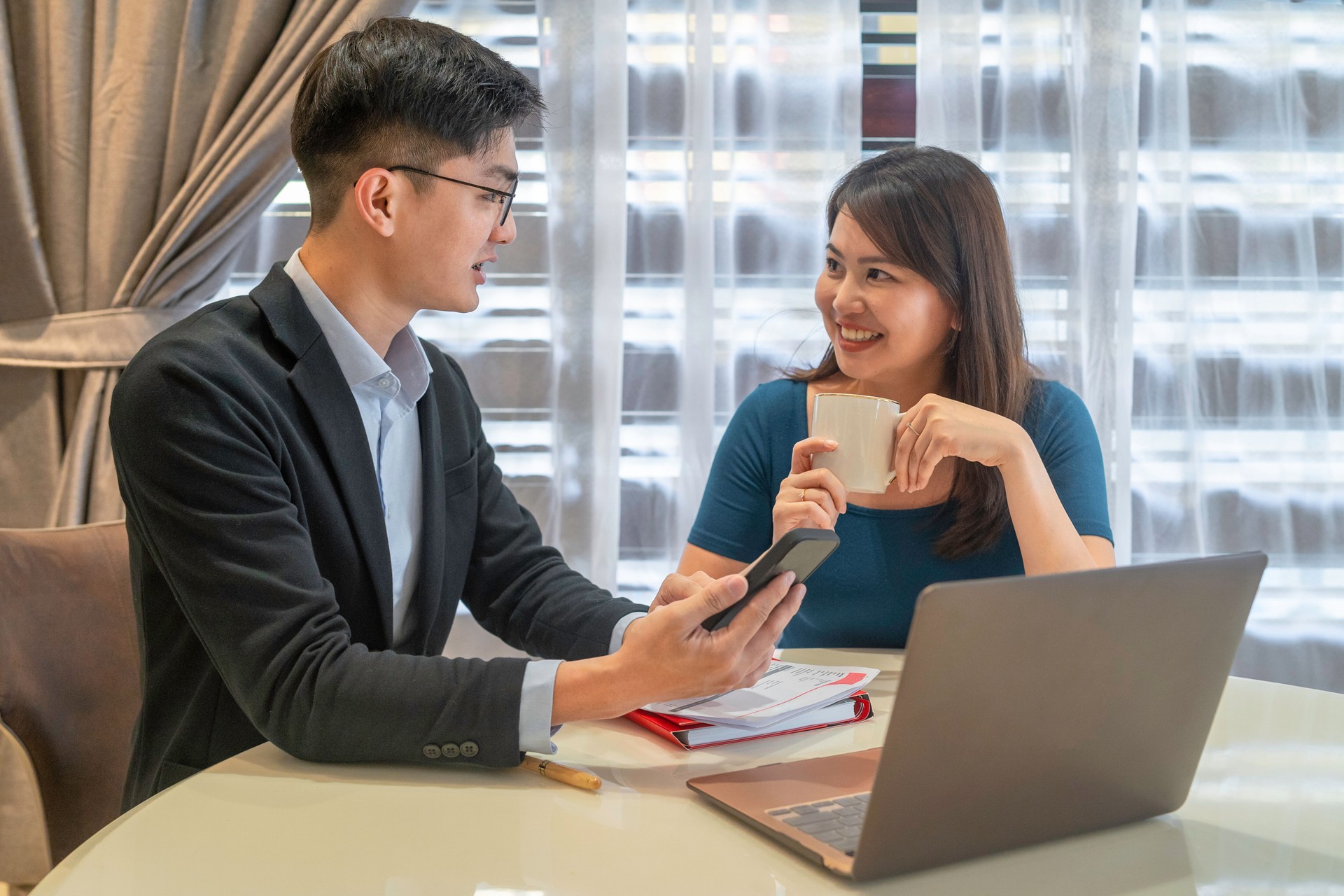 Financial advisor using a laptop with client from home
