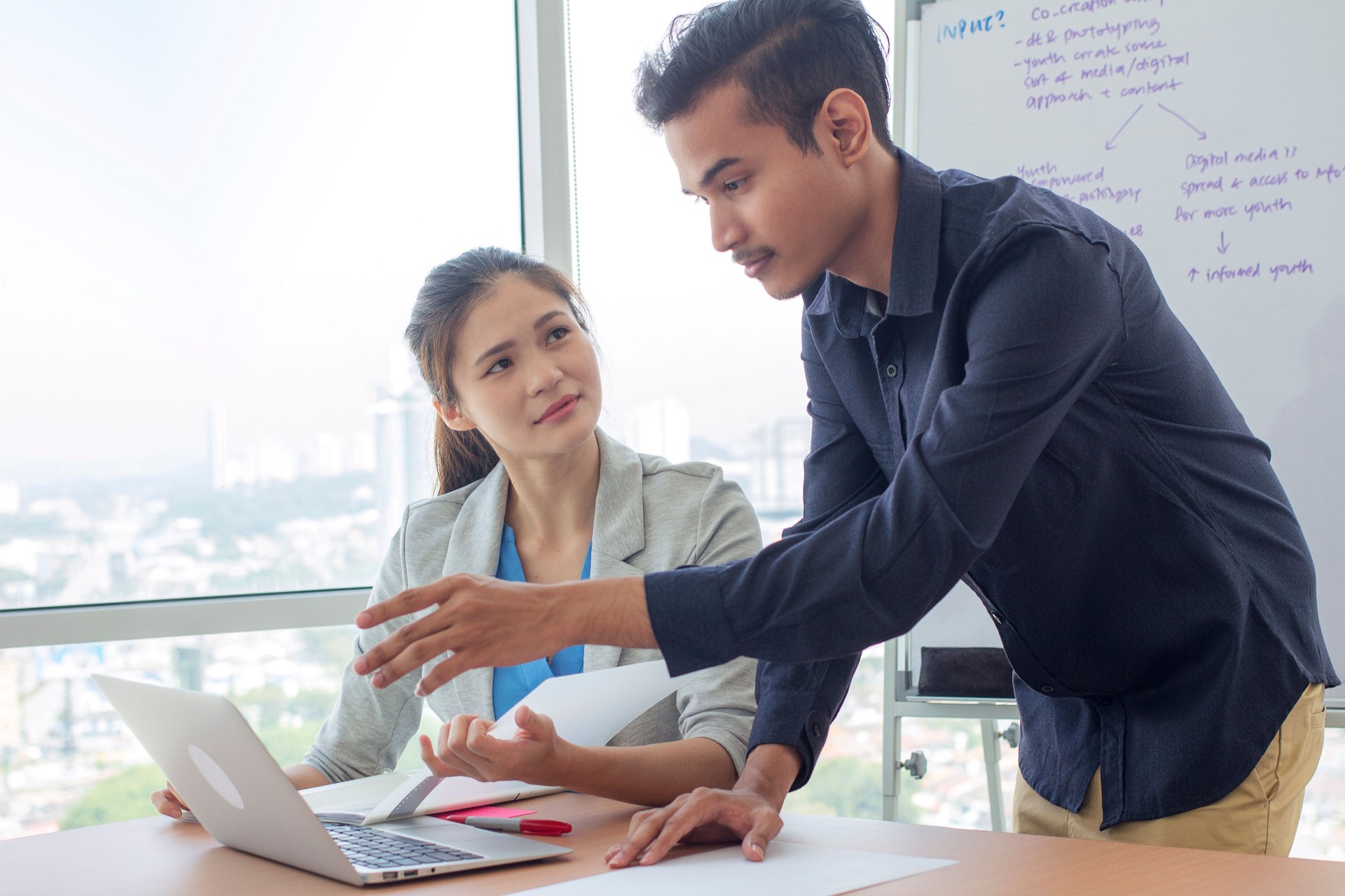 multiracial group of man and woman gather in a meeting room, discussing business plan together.